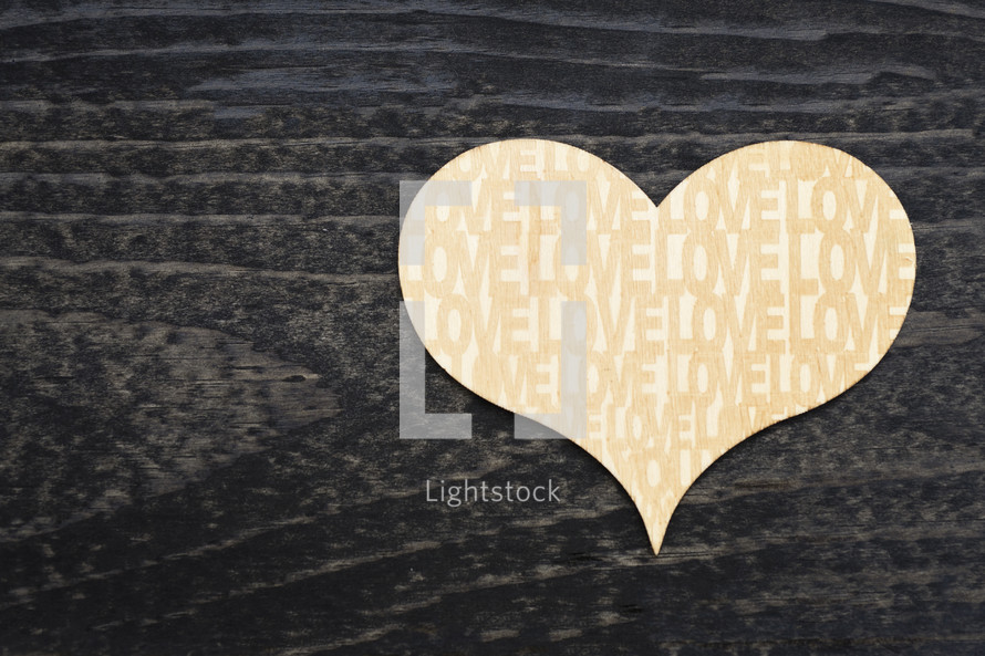 word love on a wooden heart cut out 