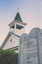 the ten commandments on a plaque in front of a church 