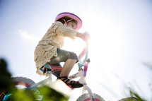 a little girl riding a bike 