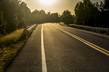 sunlight on pavement on a road 