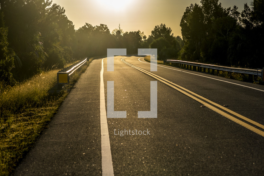 sunlight on pavement on a road 