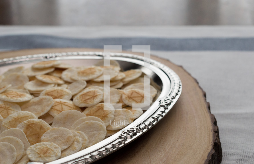 communion wafers in a silver tray 