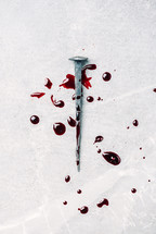 Bloody nails on grey stone background. Banner. Copy space. Good friday. Passion, crucifixion of Jesus Christ. Christian Easter holiday. Gospel, salvation.