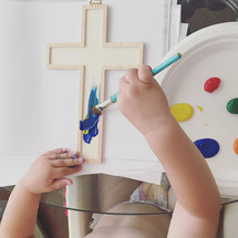 a child painting a cross 