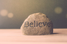 a rock with the word believe 