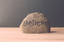 a rock with the word believe 