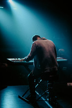 Man playing keyboard in worship setting