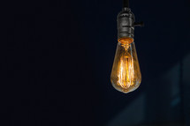 Edison bulb light and hope in the darkness