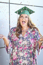 a graduate celebrating with confetti 