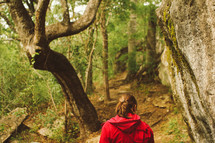 a girl hiking in a forest 