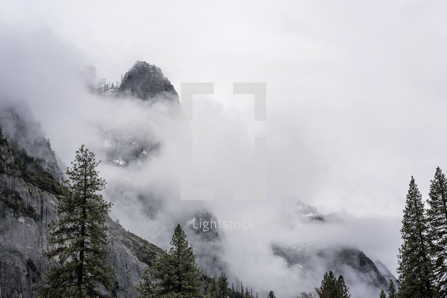 clouds and fog over a mountain peak 