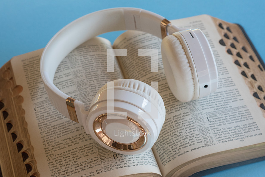 headphones on the pages of a Bible 