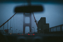 traffic on a foggy bridge 