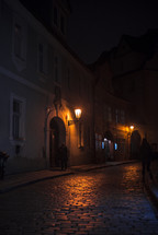 glowing street lamp and cobblestone street 