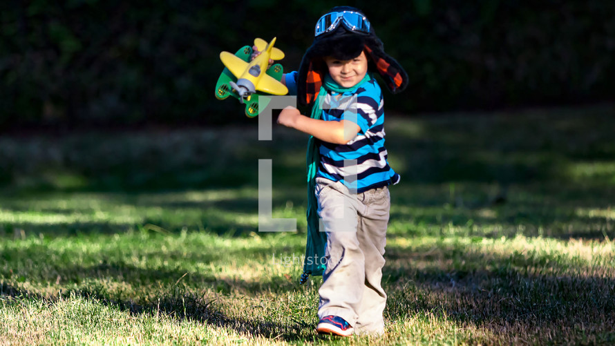child running with a toy airplane 