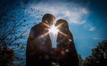 sunburst between a couple kissing 