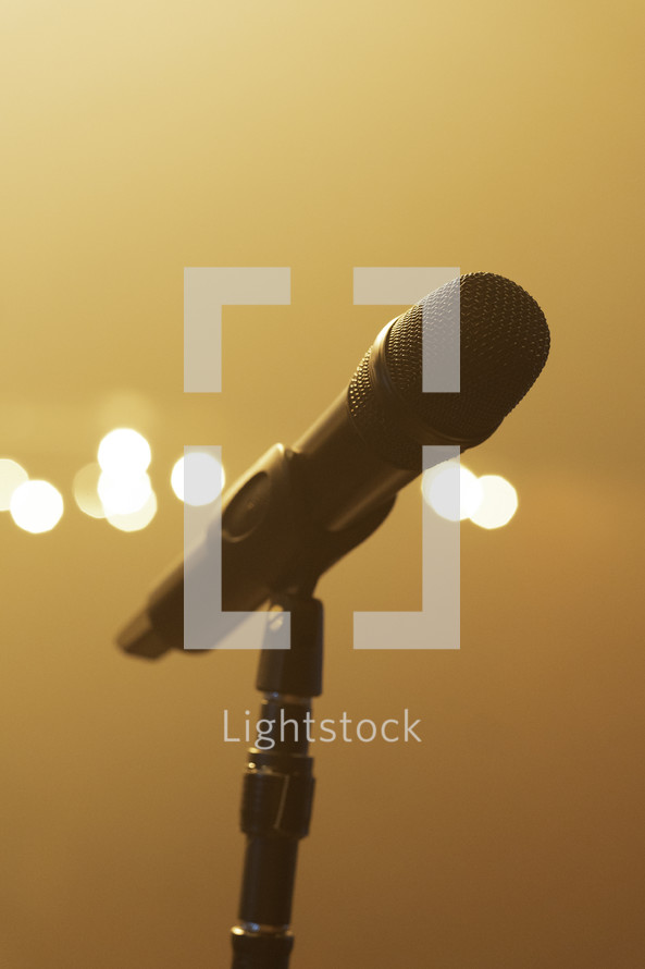 Microphone on stage at a concert, bright lights