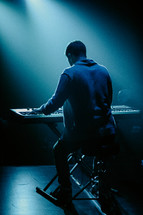 Man playing keyboard in a worship setting