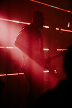 Man playing guitar on stage in worship setting