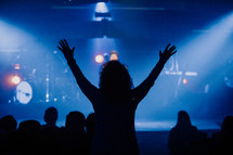 Woman with raised hands in worship