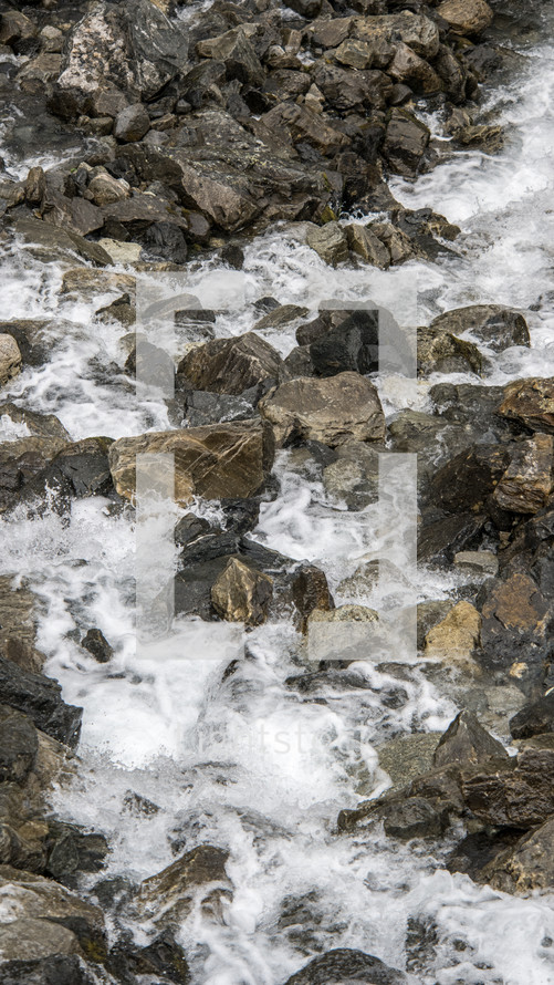 Rocks in the river water flowing down
