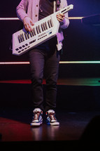 Man playing keytar on a stage