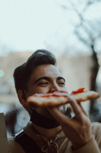 a man eating pizza 