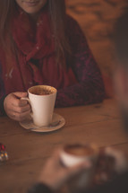 a woman drinking hot cocoa 