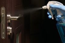 disinfecting a doorknob 