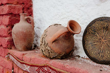 clay pottery over a fireplace 