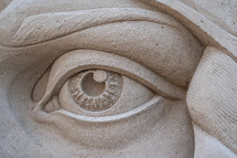 Detail of an eye from a sand sculpture