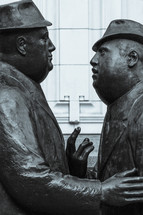 statues of Men in conversation 