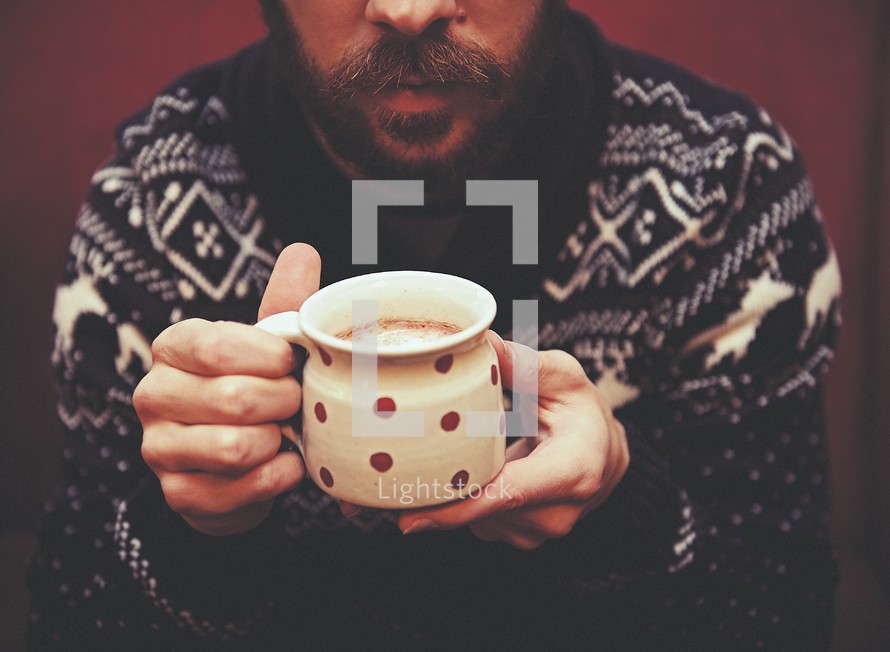 man holding a mug of hot chocolate 