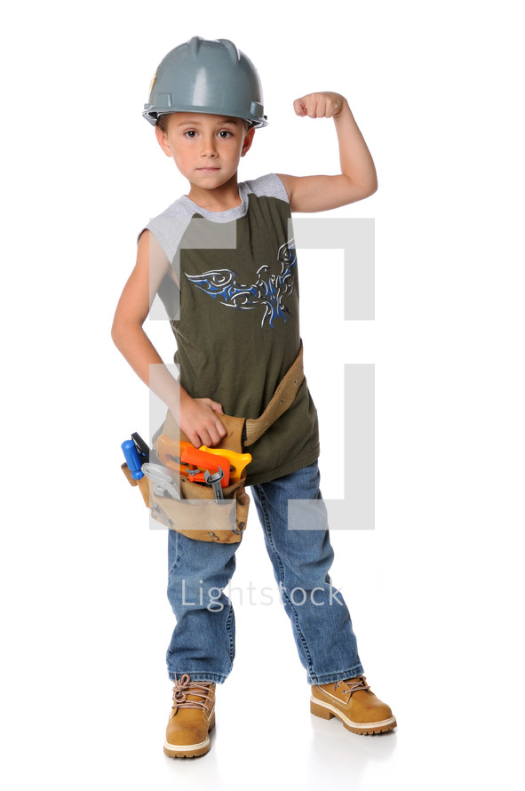A boy wearing a tool belt and hard hat flexing his muscles.