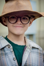 boy child wearing a hat and glasses 