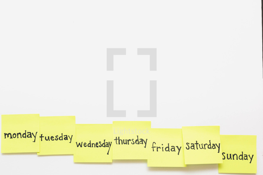 Days of the week written on yellow sticky notes.