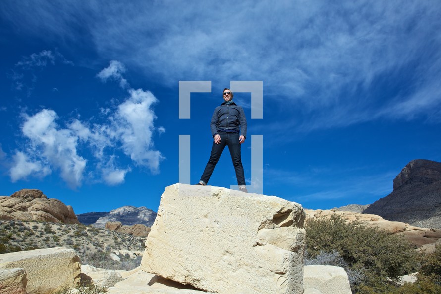 man standing on top of a rock