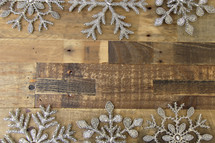 snowflake border on a wood floor background 