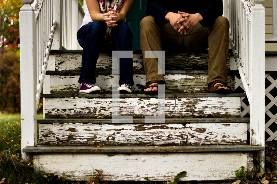 couple sitting on front steps 