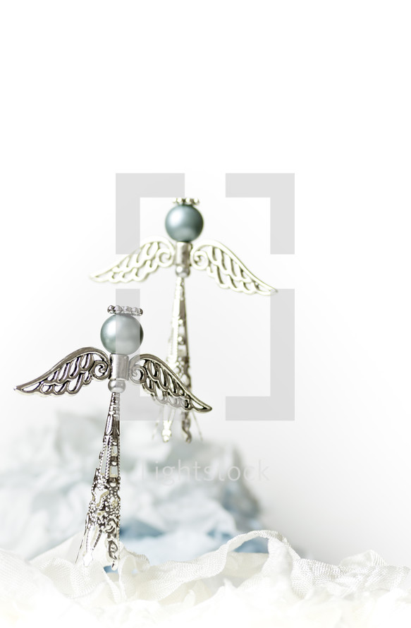 Two blue and silver Christmas angels, white background
