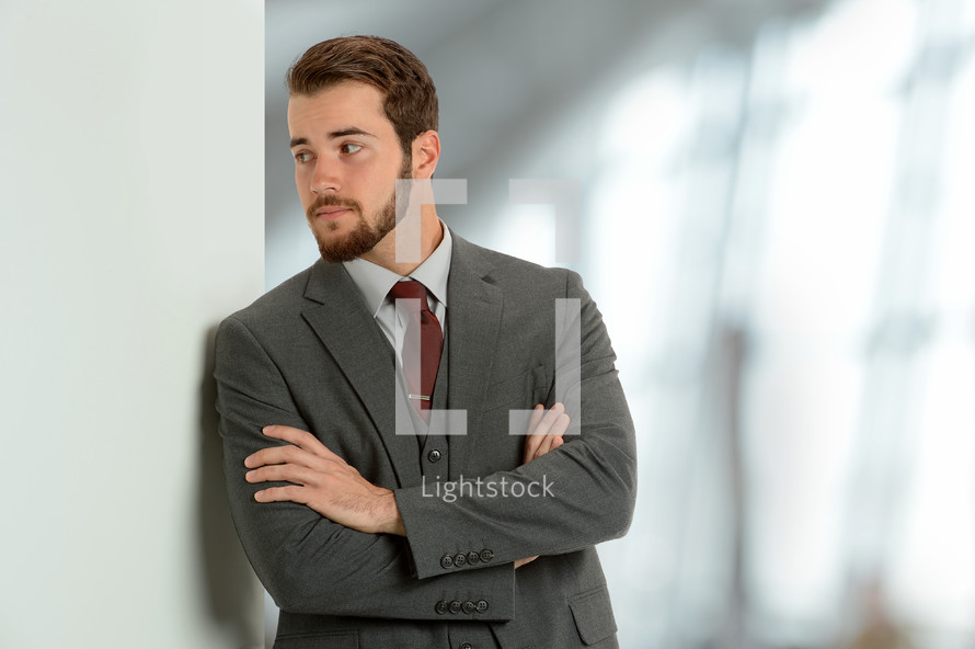man with crossed arms in a suit 
