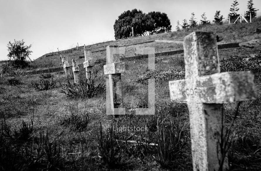 stone cross grave markers on a hill