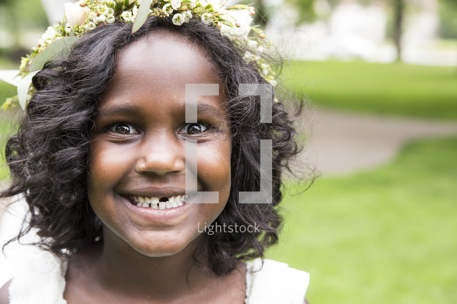 a smiling flower girl missing a tooth 