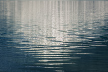Light shining on ripples in a lake.