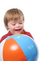 toddler boy playing with a beach ball 