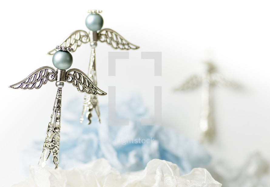 Two blue and silver Christmas angels, white background