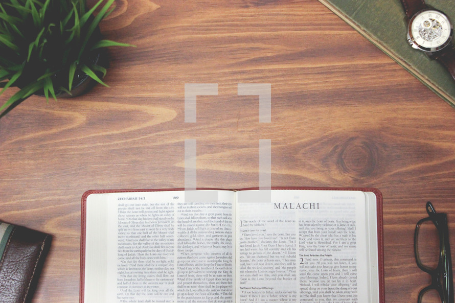 open Bible and reading glasses on a wood table - Malachi 
