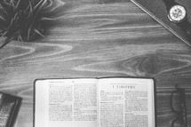 1 Timothy, open Bible, Bible, pages, reading glasses, wood table 