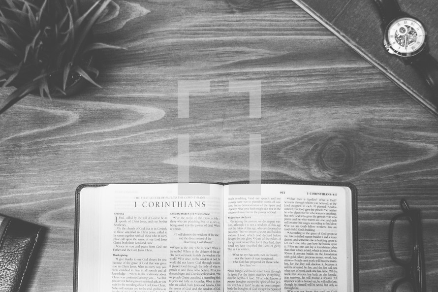 1 Corinthians, open Bible, Bible, pages, reading glasses, wood table 
