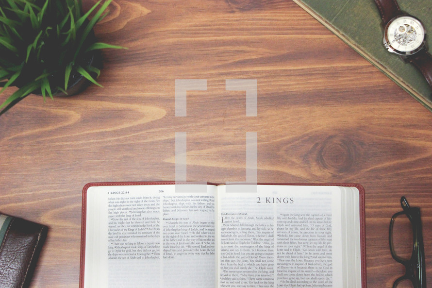 open Bible and reading glasses on a wood table - 2 Kings 